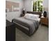 Comfortable main bedroom with large window, grey carpet, and a stylish bed providing a relaxing retreat at 17055 W 92Nd Loop, Arvada, CO 80007