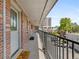 Brick apartment building with inviting balcony including a 'Hello' welcome mat at 529 N Washington St # 304, Denver, CO 80203