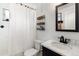 Clean bathroom featuring a shower with curtain, toilet, and vanity with stylish mirror at 529 N Washington St # 304, Denver, CO 80203