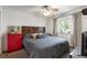 Bright bedroom featuring a ceiling fan, window with curtains, and a wooden headboard at 529 N Washington St # 304, Denver, CO 80203