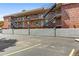 Brick apartment building with multiple exterior staircases and designated parking spaces at 529 N Washington St # 304, Denver, CO 80203