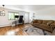 Living room with hardwood floors, a comfortable sofa, and a bright window view at 529 N Washington St # 304, Denver, CO 80203