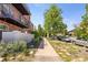 A street view of a brick apartment building with beautiful vegetation along the sidewalk at 529 N Washington St # 304, Denver, CO 80203