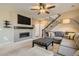 Living room with sectional sofa, fireplace, and hardwood floors at 9638 Albion Ln, Thornton, CO 80229