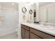 Clean bathroom with double vanity and a bathtub at 13455 Valentia Pl, Thornton, CO 80602