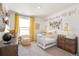 Adorable Bedroom with crib, dresser, and whimsical decor at 13455 Valentia Pl, Thornton, CO 80602