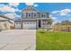 Two-story house with gray siding, white trim, and a three-car garage at 13455 Valentia Pl, Thornton, CO 80602