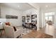 Bright home office features built-in shelving and hardwood floors at 13455 Valentia Pl, Thornton, CO 80602