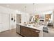 Modern kitchen island with sink and stainless steel dishwasher; open floor plan at 13455 Valentia Pl, Thornton, CO 80602