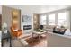 Living room with a fireplace and large windows at 13455 Valentia Pl, Thornton, CO 80602