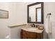 Powder room with vanity, sink, and decorative mirror at 1043 Meteor Pl, Castle Rock, CO 80108