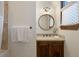 Charming bathroom with a round mirror and wooden vanity at 1043 Meteor Pl, Castle Rock, CO 80108