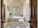 Spa-like bathroom with soaking tub and large window at 1043 Meteor Pl, Castle Rock, CO 80108