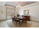 Formal dining room with hardwood floors, chandelier, and access to patio at 1043 Meteor Pl, Castle Rock, CO 80108