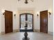 Elegant entryway with double doors, a round table, and a chandelier at 1043 Meteor Pl, Castle Rock, CO 80108