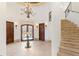 Grand entryway with a circular floor plan, staircase, and chandelier at 1043 Meteor Pl, Castle Rock, CO 80108