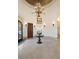 Circular two-story foyer with a dramatic chandelier and tiled floor at 1043 Meteor Pl, Castle Rock, CO 80108