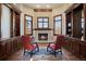 Elegant library with built-in bookshelves and a cozy fireplace at 1043 Meteor Pl, Castle Rock, CO 80108