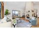 Bright living room features a large stone fireplace and hardwood floors at 1043 Meteor Pl, Castle Rock, CO 80108