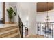 Elegant staircase with wrought iron railing and tiled flooring at 1043 Meteor Pl, Castle Rock, CO 80108