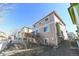 Backyard of a multi-story house with wooden deck and staircase surrounded by gravel landscaping at 3565 E 141St Dr, Thornton, CO 80602