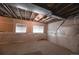 Unfinished basement with exposed ceiling joists, some insulation, and two windows for natural light at 3565 E 141St Dr, Thornton, CO 80602