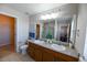 Bathroom featuring dual sinks, a large mirror, and a separate toilet room and shower stall at 3565 E 141St Dr, Thornton, CO 80602