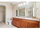 Bathroom featuring double sinks, granite counters, and a separate shower at 3565 E 141St Dr, Thornton, CO 80602