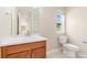 Bathroom featuring a vanity with white countertop, light wood cabinets, and a window for natural light at 3565 E 141St Dr, Thornton, CO 80602