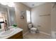 This bathroom features neutral walls, a single sink vanity, and a toilet with a window at 3565 E 141St Dr, Thornton, CO 80602