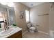 Bright bathroom with a ceramic tile floor, sink, toilet and bathtub with a window for natural lighting at 3565 E 141St Dr, Thornton, CO 80602