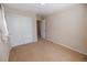 Neutral carpeted bedroom with a closet, door and neutral paint throughout the room at 3565 E 141St Dr, Thornton, CO 80602