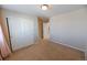 Empty bedroom with neutral walls, carpet, closet, and simple design, ready for personalization and comfort at 3565 E 141St Dr, Thornton, CO 80602