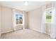 Well-lit bedroom with neutral carpet and two windows at 3565 E 141St Dr, Thornton, CO 80602