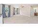 Spacious bonus room with plush carpeting, natural light from two windows, and a ceiling fan at 3565 E 141St Dr, Thornton, CO 80602