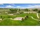 Aerial view of community park featuring a pond, playground, and well-maintained grass at 3565 E 141St Dr, Thornton, CO 80602