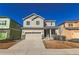 Charming two-story home featuring a two-car garage, covered entry, and neutral-colored siding under a clear blue sky at 3565 E 141St Dr, Thornton, CO 80602