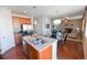 Spacious kitchen showcases an island with barstools, stainless steel appliances, and opens to living areas at 3565 E 141St Dr, Thornton, CO 80602