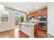 Well-equipped kitchen with a center island, stainless steel appliances, and sliding glass doors to the deck at 3565 E 141St Dr, Thornton, CO 80602