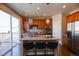 Kitchen island with barstool seating, granite countertops, stainless appliances and glass doors to a deck at 3565 E 141St Dr, Thornton, CO 80602