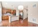 Open-concept kitchen featuring a center island, stainless steel appliances, and hardwood floors at 3565 E 141St Dr, Thornton, CO 80602