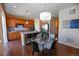 Open-concept kitchen showcases an island with seating, wood cabinets, and stainless steel appliances at 3565 E 141St Dr, Thornton, CO 80602