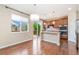 Bright kitchen with a center island, modern pendant lighting, and stainless steel appliances at 3565 E 141St Dr, Thornton, CO 80602
