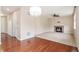 Cozy living room with hardwood flooring, fireplace, and decorative chandelier at 3565 E 141St Dr, Thornton, CO 80602