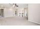 Upstairs living room with neutral carpet, ceiling fan, and stairway access at 3565 E 141St Dr, Thornton, CO 80602
