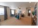 Comfortable living room features neutral walls, plush seating, and large windows with elegant curtains at 3565 E 141St Dr, Thornton, CO 80602