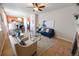 Open living area showcases a fireplace and seamless transition to kitchen with stainless appliances and breakfast bar at 3565 E 141St Dr, Thornton, CO 80602