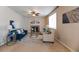 Comfortable living room featuring a ceiling fan, fireplace, neutral decor, and ample natural light at 3565 E 141St Dr, Thornton, CO 80602