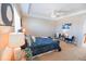 Spacious main bedroom with plush bedding, soft lighting, and a sitting area creating a peaceful retreat at 3565 E 141St Dr, Thornton, CO 80602