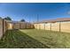 Large backyard featuring a new wooden fence and green grass, perfect for outdoor enjoyment at 3201 Albion St, Denver, CO 80207